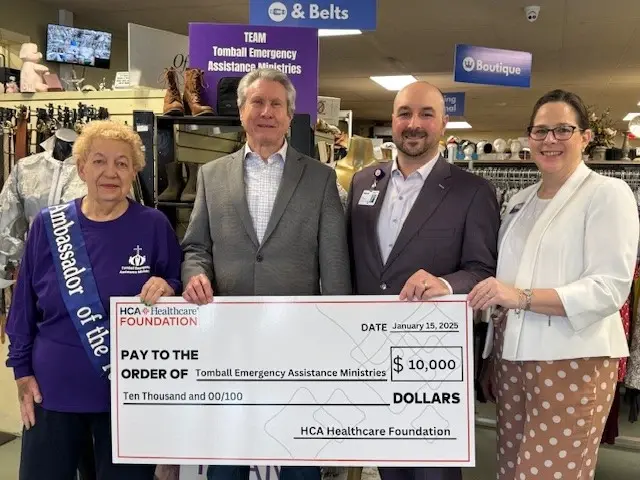 Representatives posing with donation check.