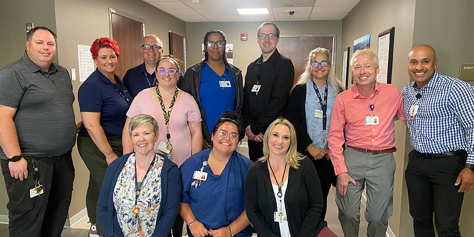 ACT team posing together in the hallway.