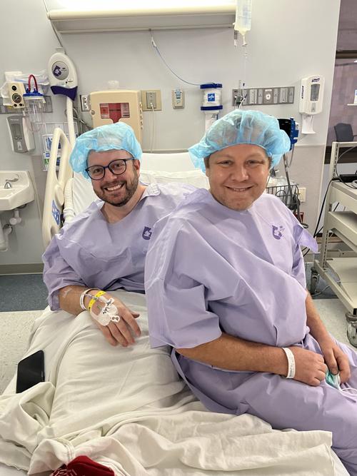 Keith and Lee Masterson in posing in hospital bed.