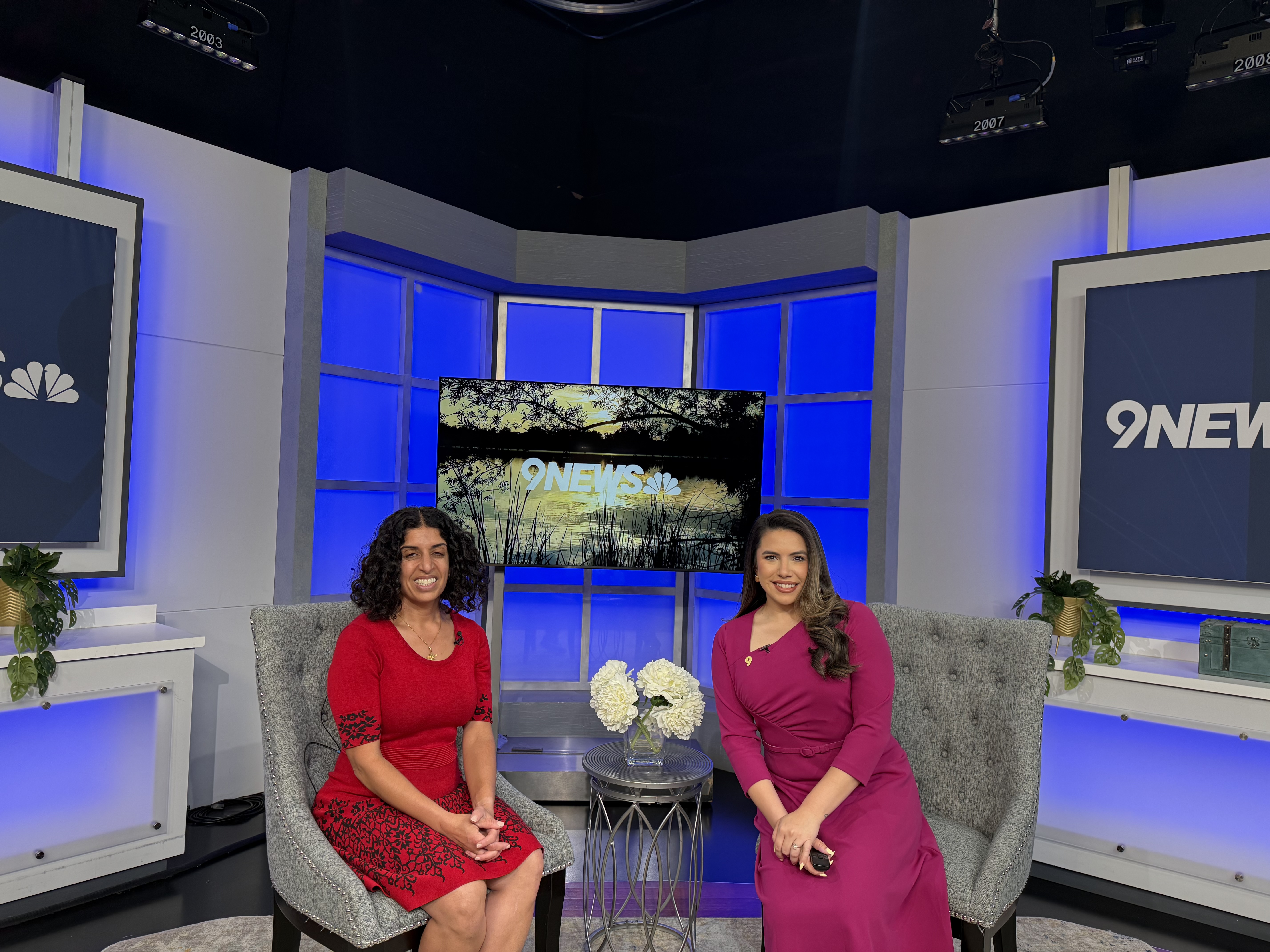 Dr. Katayun Irani with the 9News host, smiling for a picture on the 9News set.