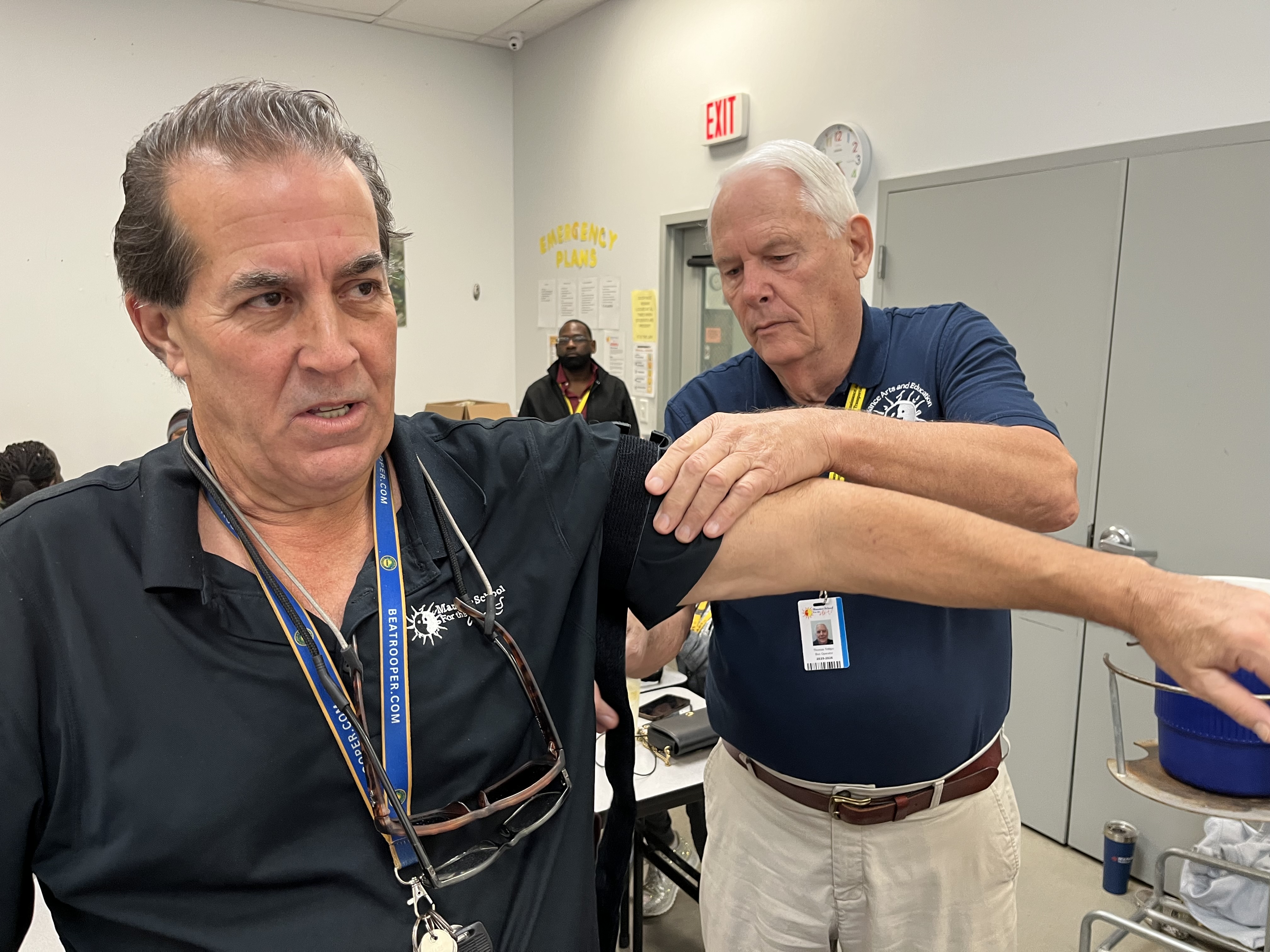 A participant in the Stop the Bleed training holds up his arm during a demonstration