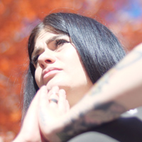 Alicia Fisher does a yoga pose outdoors on a fall day.