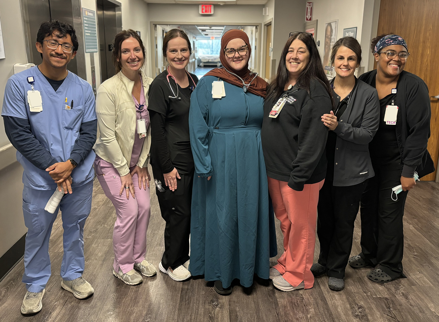 April Lane with teammates in hospital hallway.