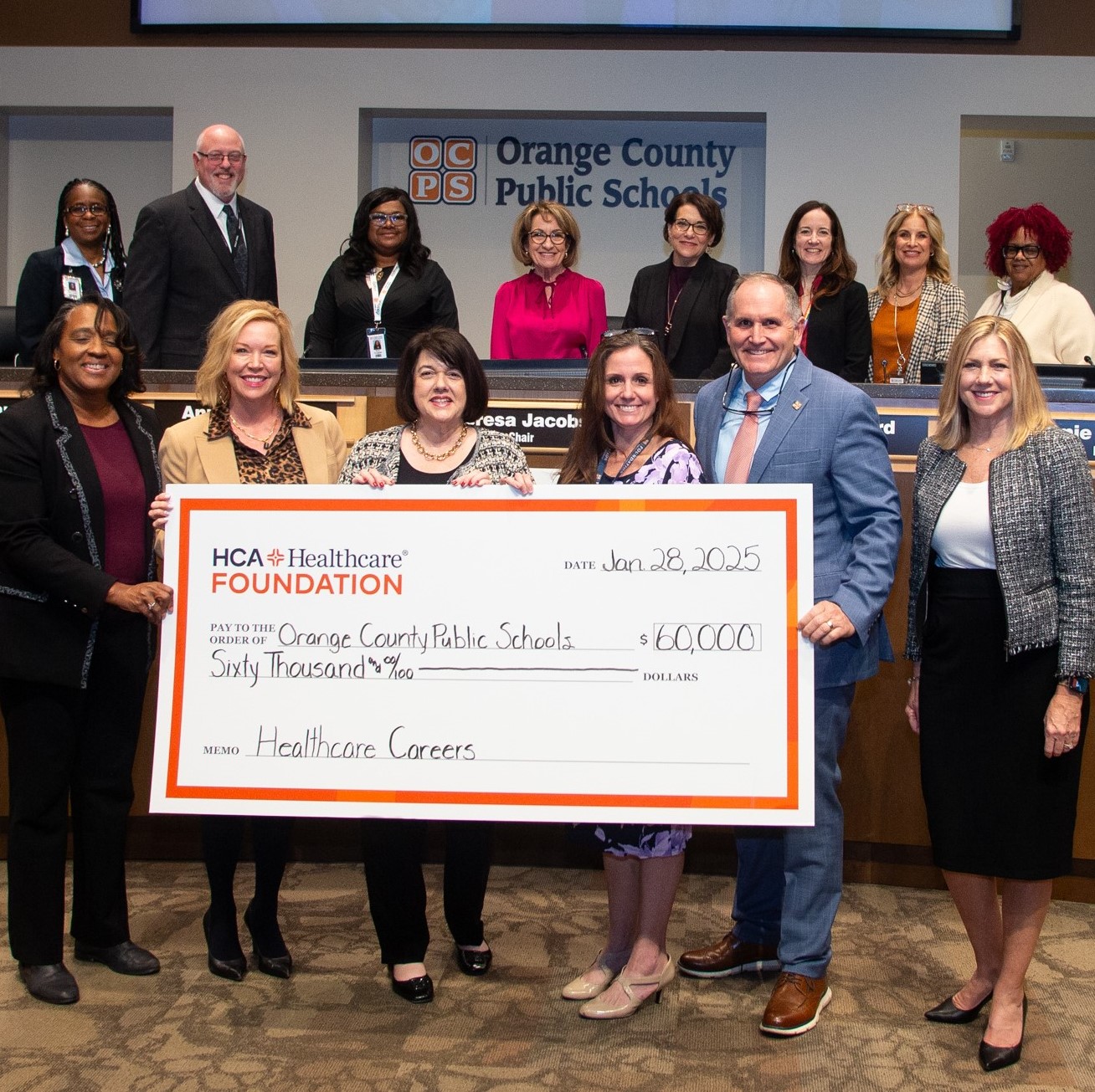 Staff receives a check at an award conference.