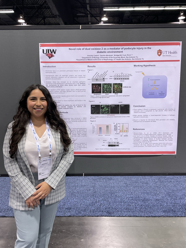Aracely Castro standing next to a research presentation