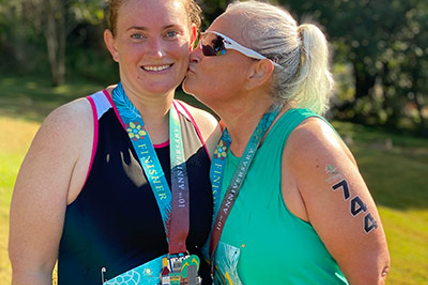 Mackenzie Mitchell being kissed on the cheek by her mother.