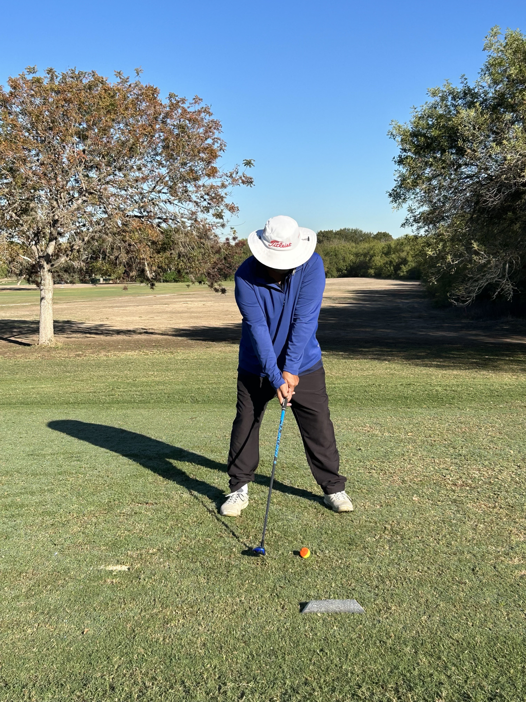 Juan Vasquez patient is golfing, about to swing.