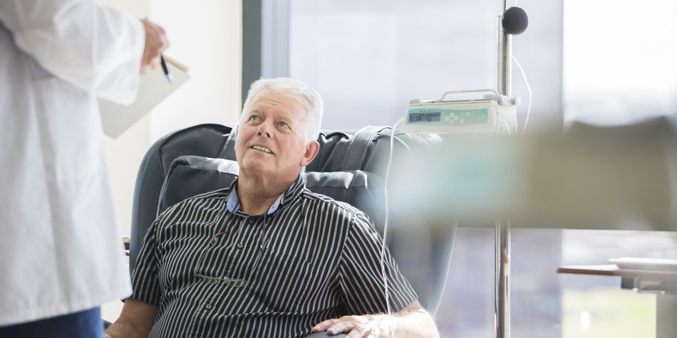Senior man sitting in chair during doctor consultation.