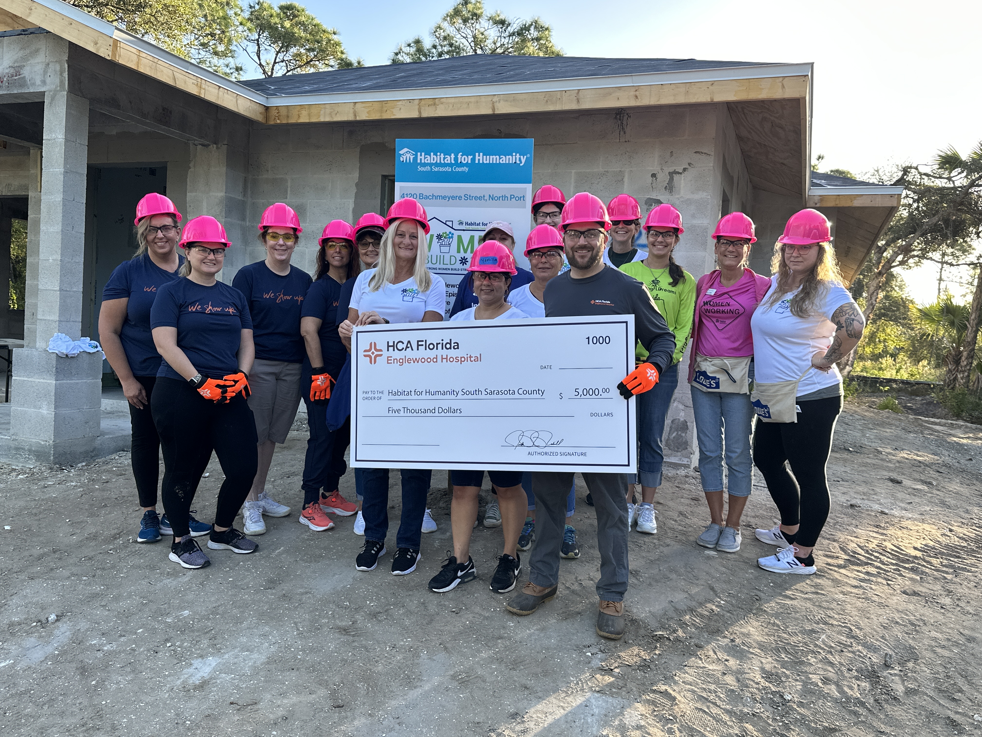 HCA Community Volunteers with check for Habitat for Humanity