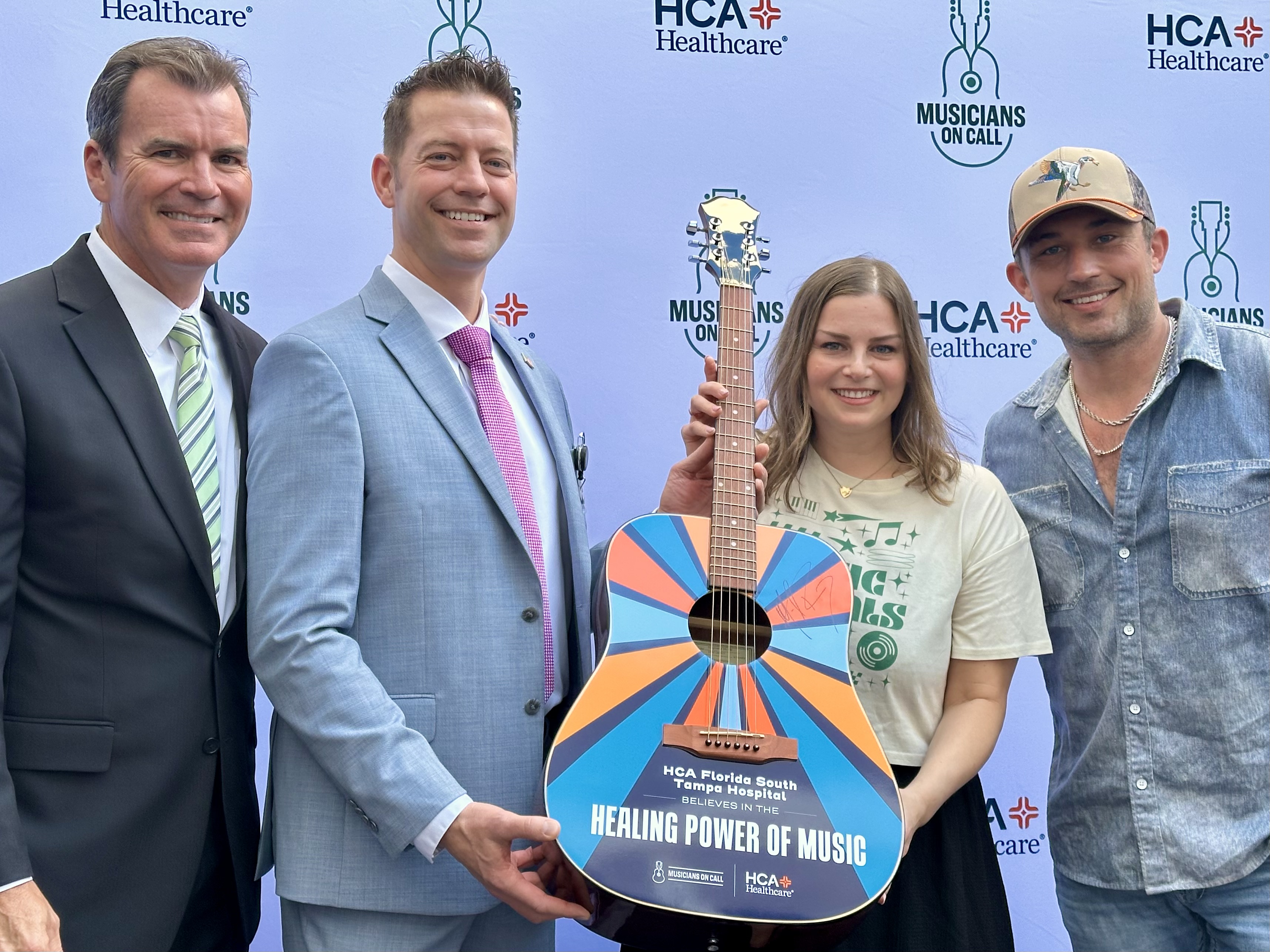Musicians On Call presents guitar autographed by musical artist Michael Ray to HCA Florida South Tampa Hospital.