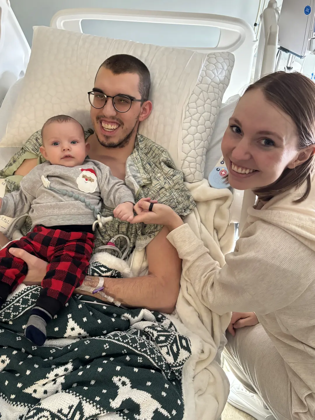 McKenna with her husband and child in hospital bed