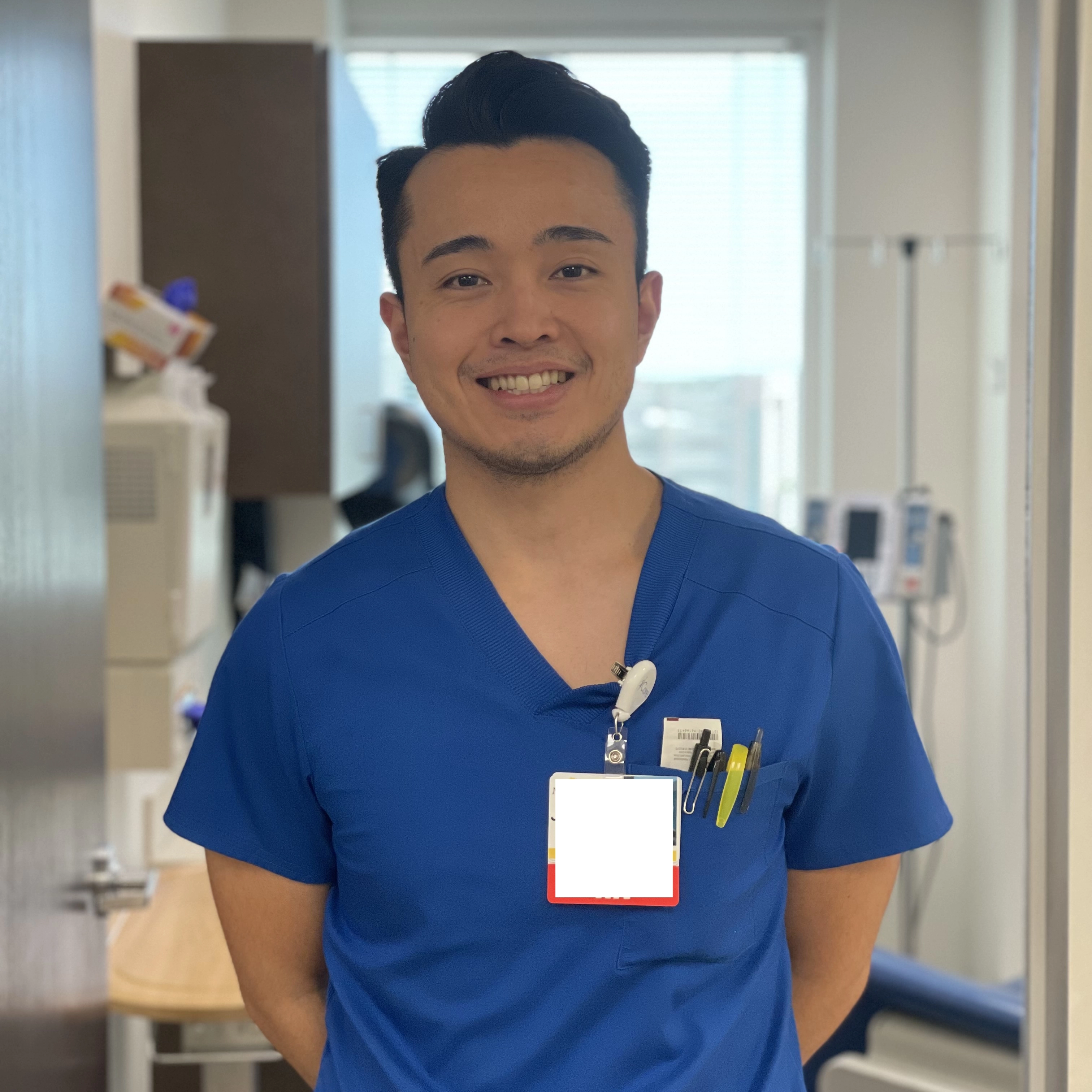 Jonathan Nakagawa standing in the hospital smiling.