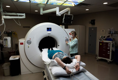 A specialist prepares Nicole Villalpando to undergo a scan in the HeartSaver CT lab.
