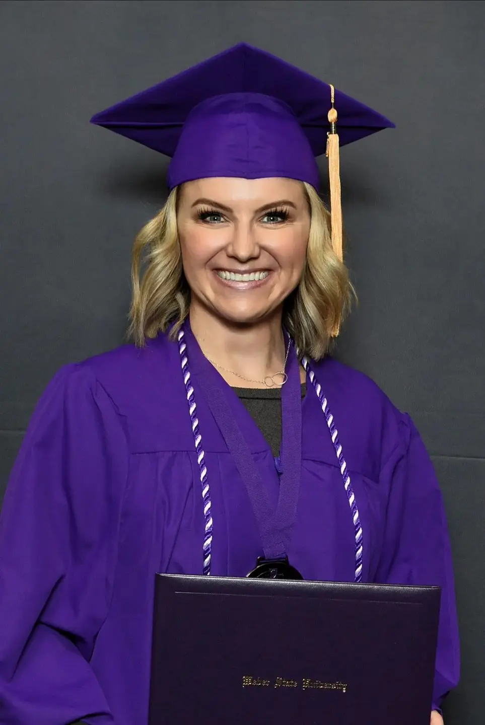 Gina Corry in graduate cap and gown.