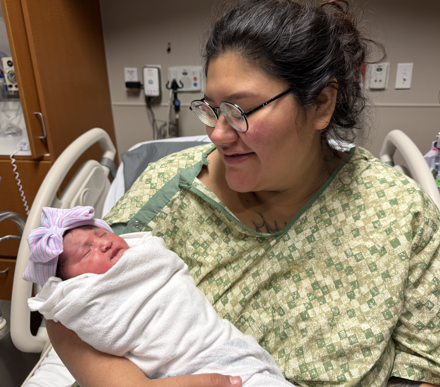 Melissa Jose Bautista in hospital bed holding newborn baby Kaya.