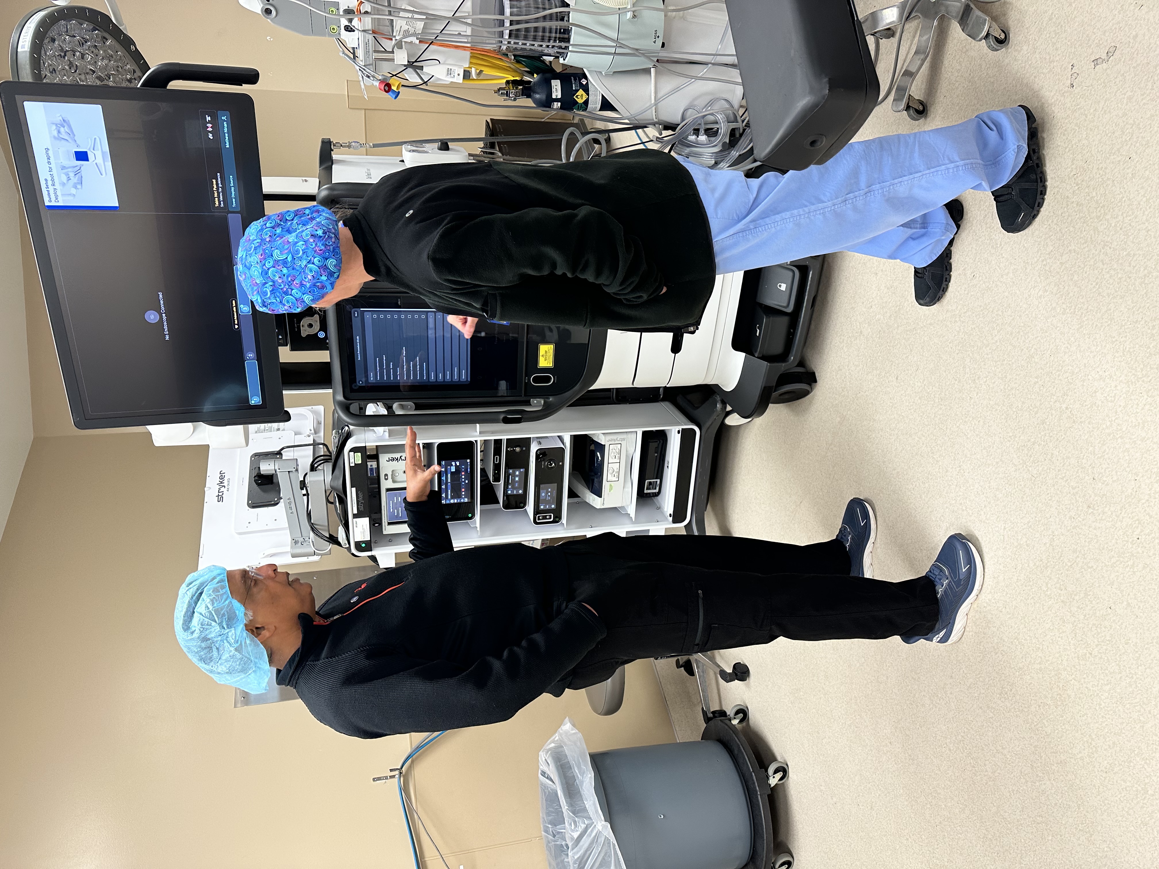 Surgeons in front of robotic surgery technology.