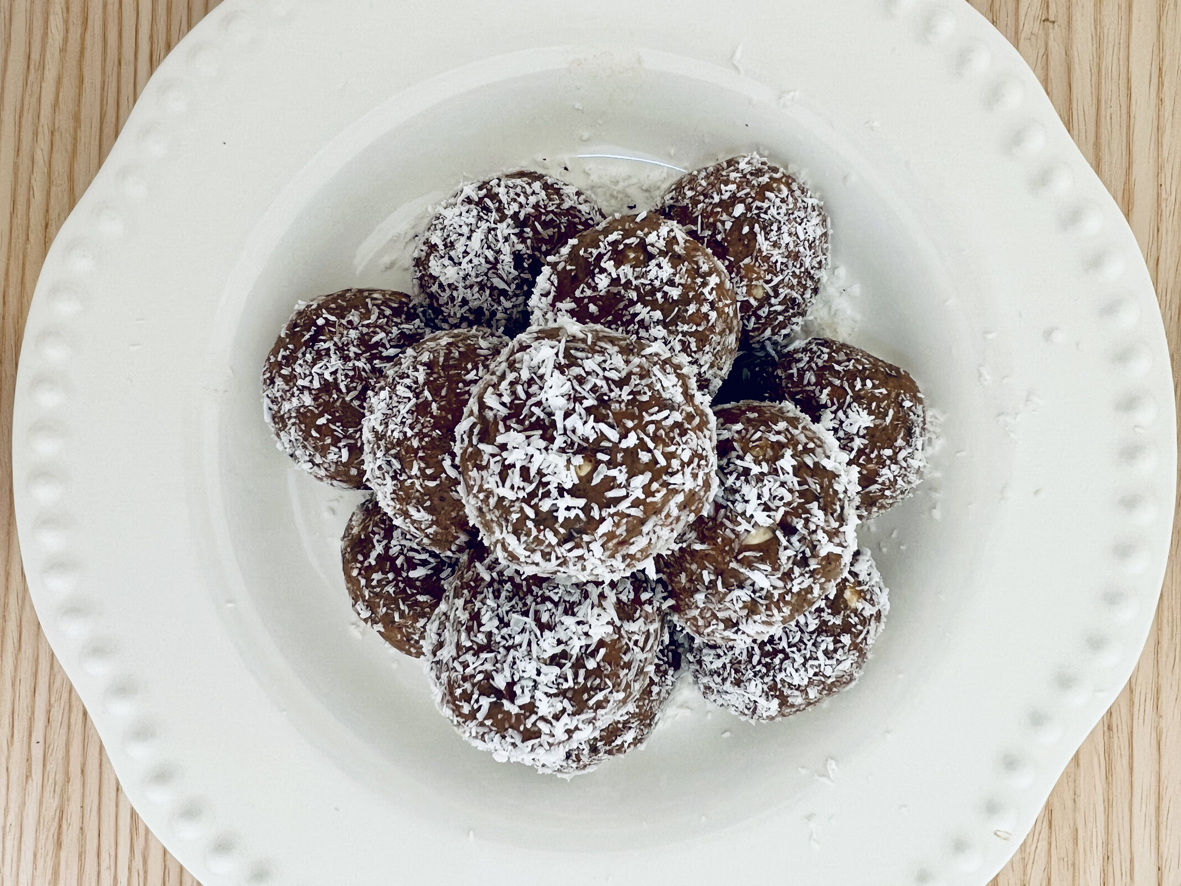 Nutty energy bites on a white plate.