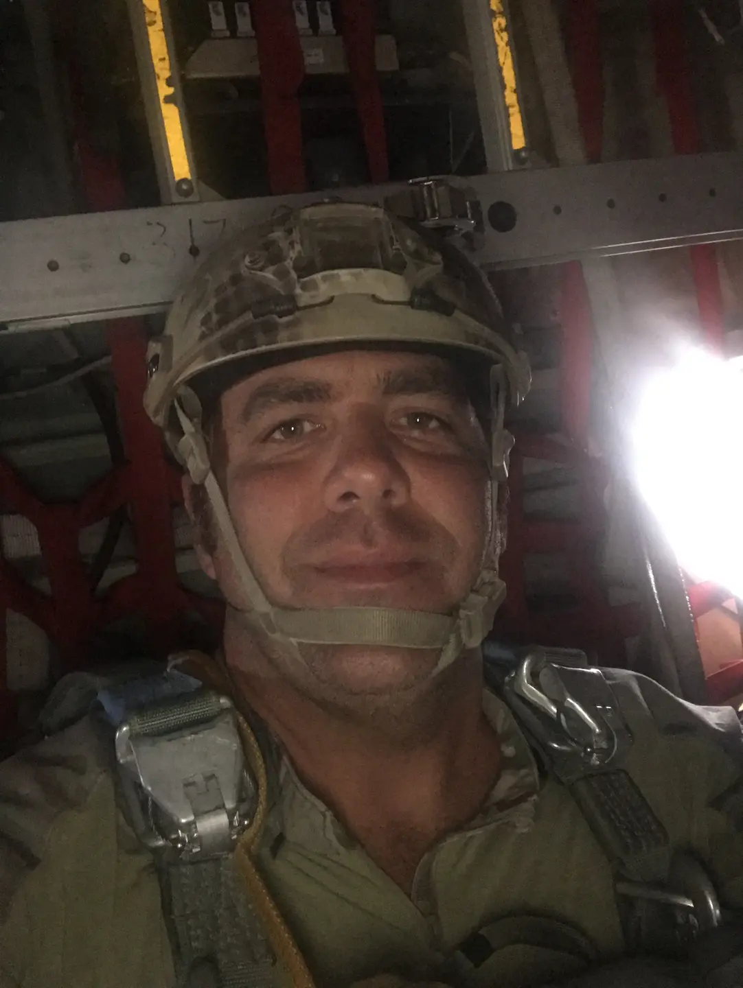 Ed Prescott smiles while sitting in a military airplane.