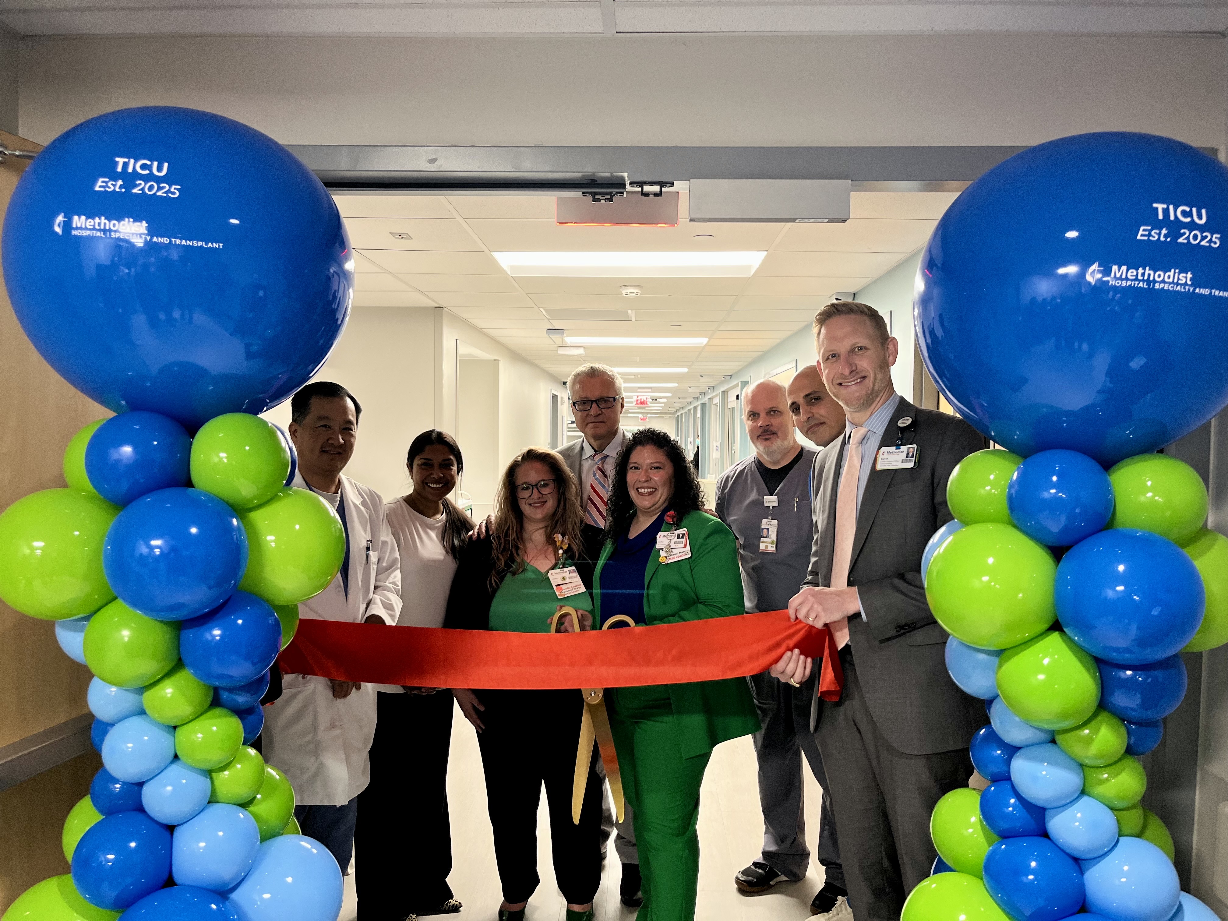 Senior leaders and physicians cutting the ribbon.