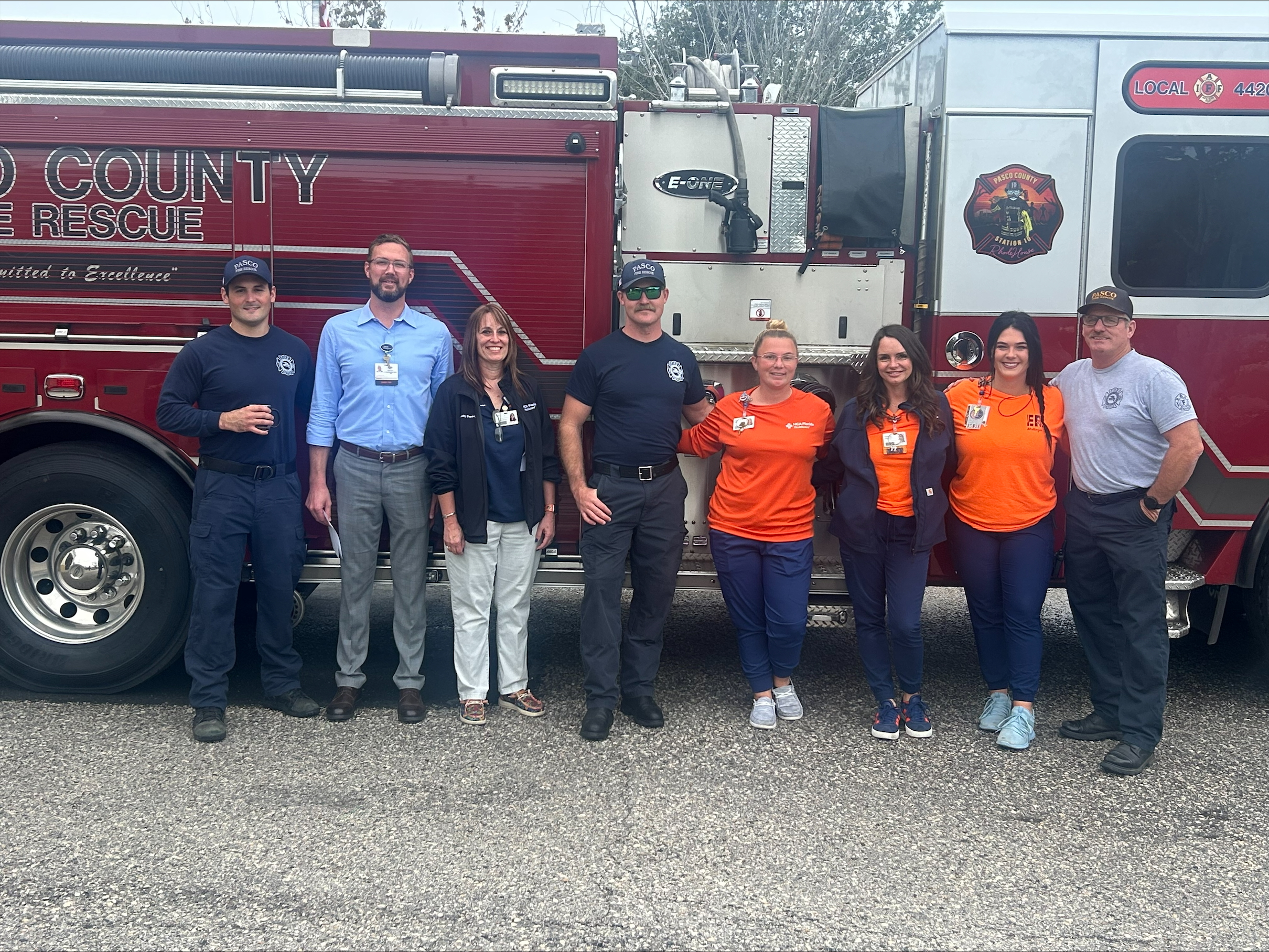 Bayonet Point Hospitla team with Pasco County Fire Rescue team in front of fire truck.