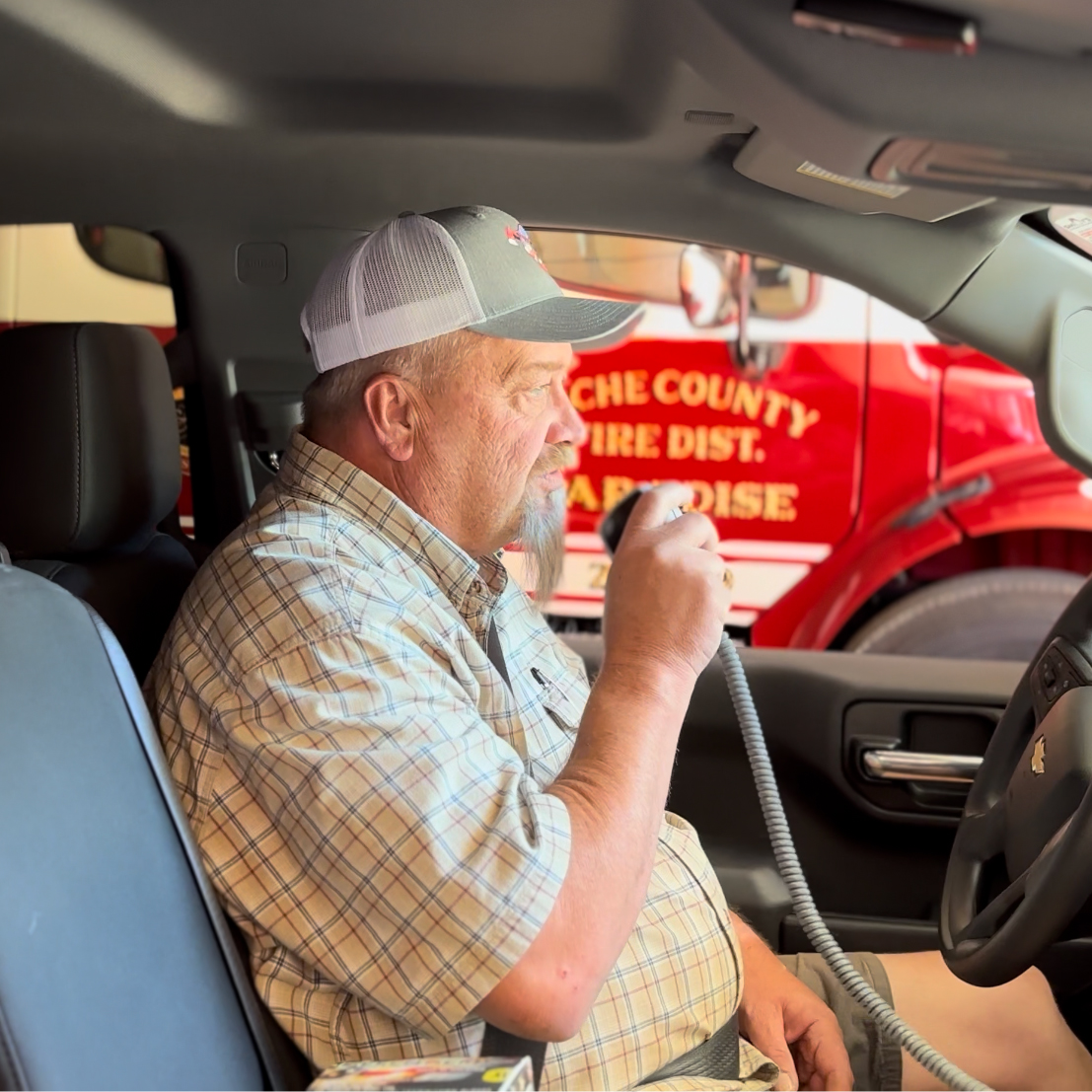 Jerry Pulsipher making in his truck making a call on the CB Radio in the firehouse garage.
