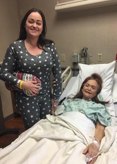 Hermelinda "Melly" Laurel, in her hospital bed, with her daughter Loreena at her side.