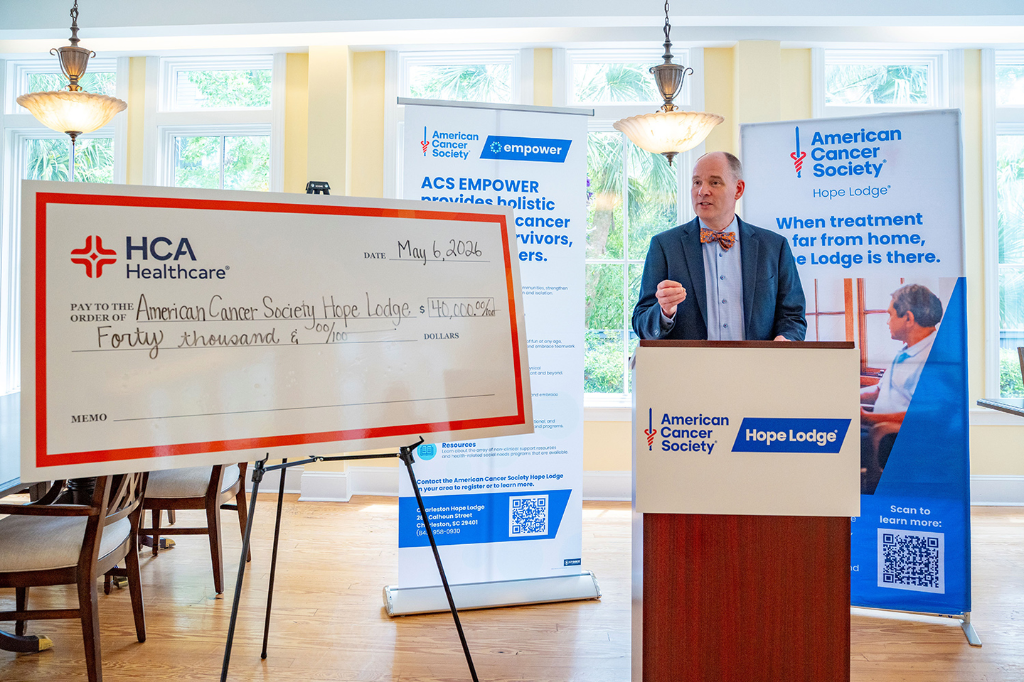 Jeff WIlson at podium presenting donation check.
