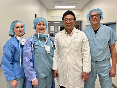 Dr. Aaron Lee and his team smile before performing a new robotic surgery procedure at Riverside Community Hospital.