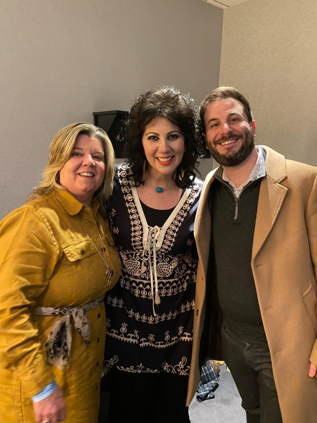 Issacs with Gretchen Miller, director of rehabilitation services, and Dr. Scott Mandell backstage at the Grand Ole Opry.
