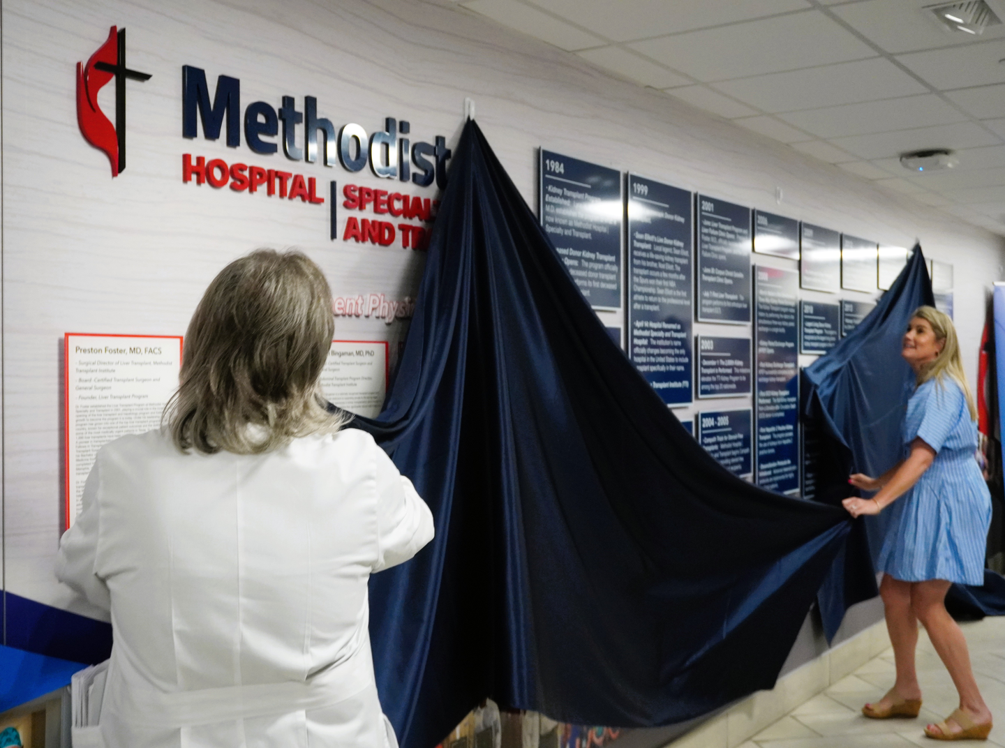 Photo showing of two female Methodist Healthcare team members during the new history wall ceremony.
