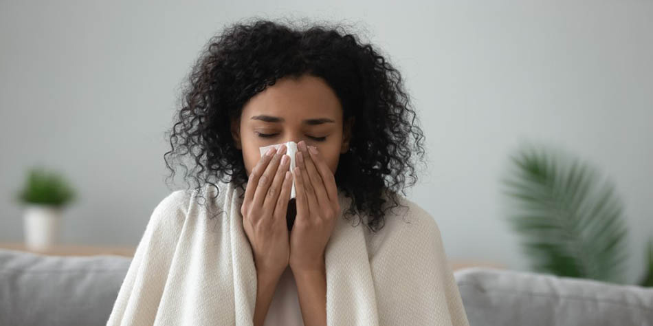Woman blowing her nose