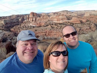Michael Nixon and his family outside, with Utah mountains in the background.