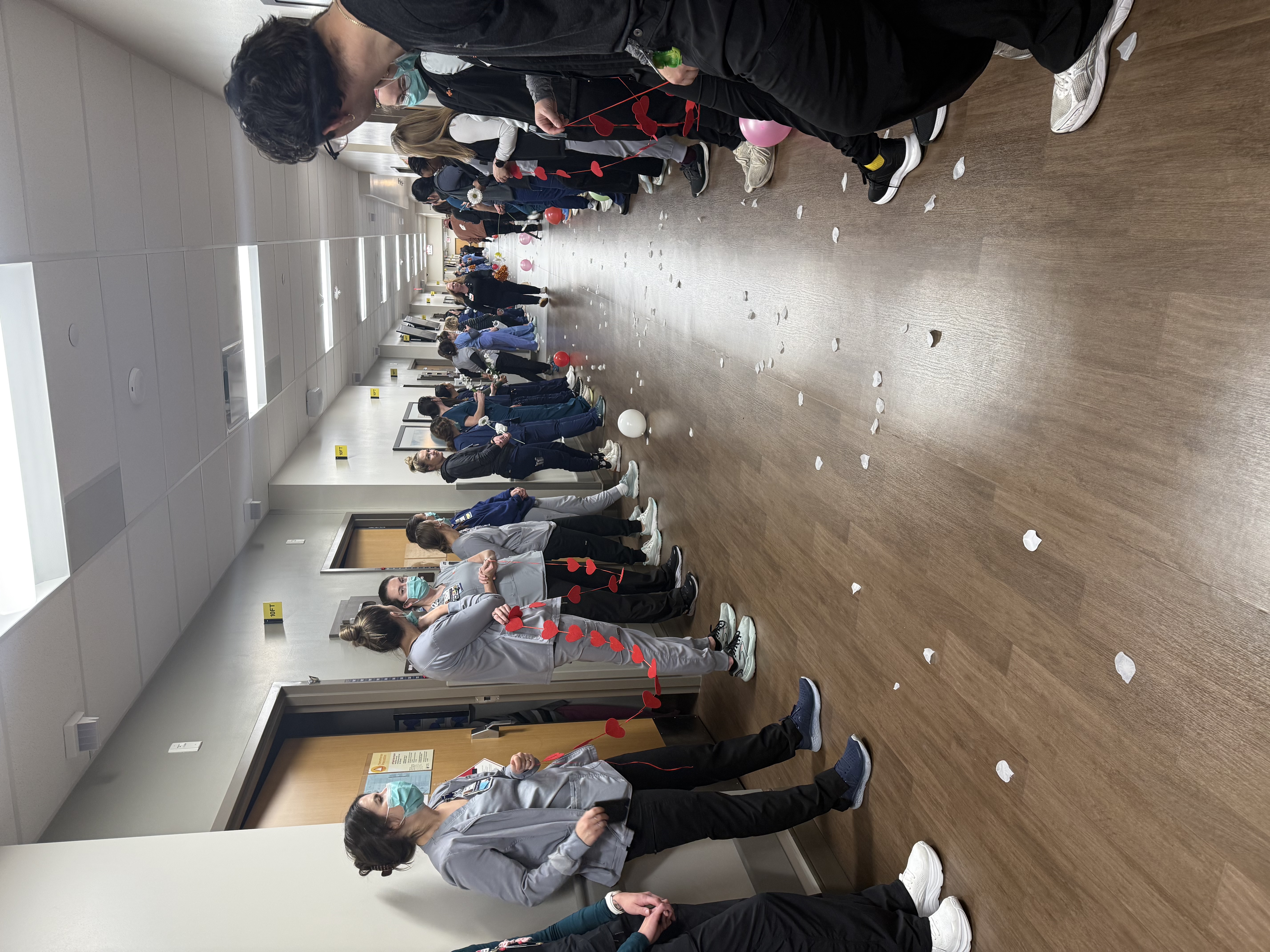 Colleagues from HCA HealthONE Swedish line the halls in advance of the wedding.