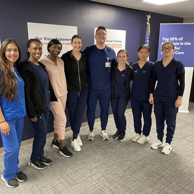 Group of healthcare providers standing in a room.