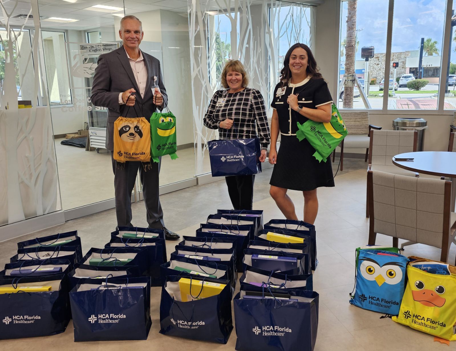 Fawcett Hospital staff posing with school supply donation bags