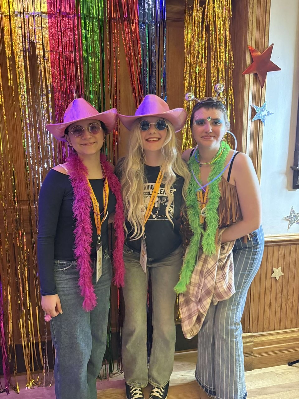 Arcie Lovato, Anna Reed, and friend in party gear at celebration event.
