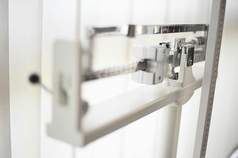 A metal scale for a person to be weighed on.