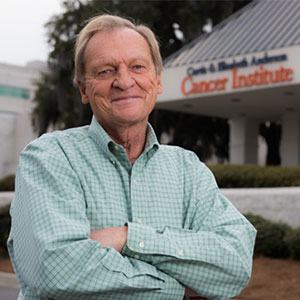 Gary Exley standing in front of the cancer institute.