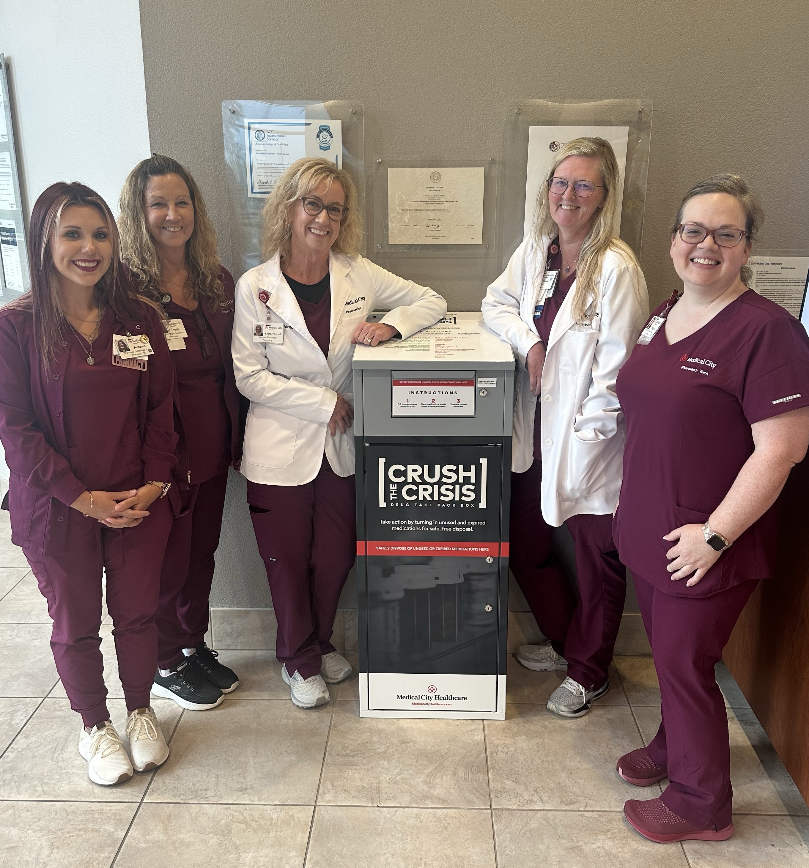people gathered around an open to the public secure "crush the crisis" drug drop box in Medical City Decatur’s main lobby