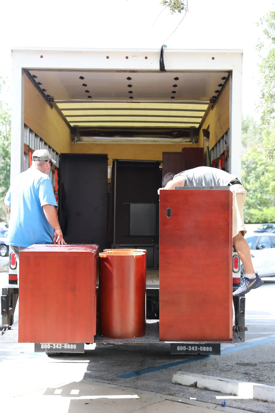Furniture being moved off a truck.