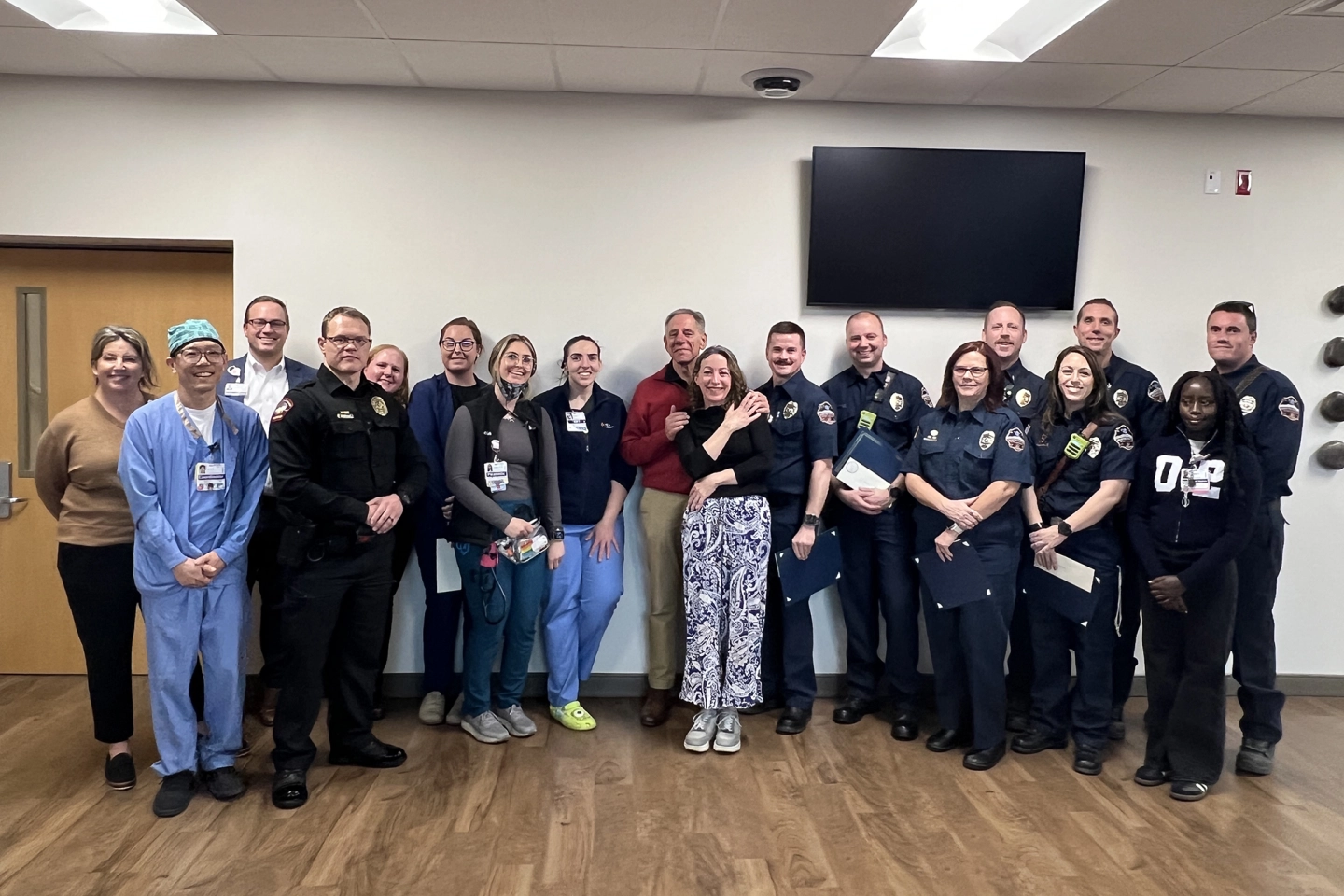 First responders and care team members from HCA HealthONE Swedish gather with patient Craig Morroni.