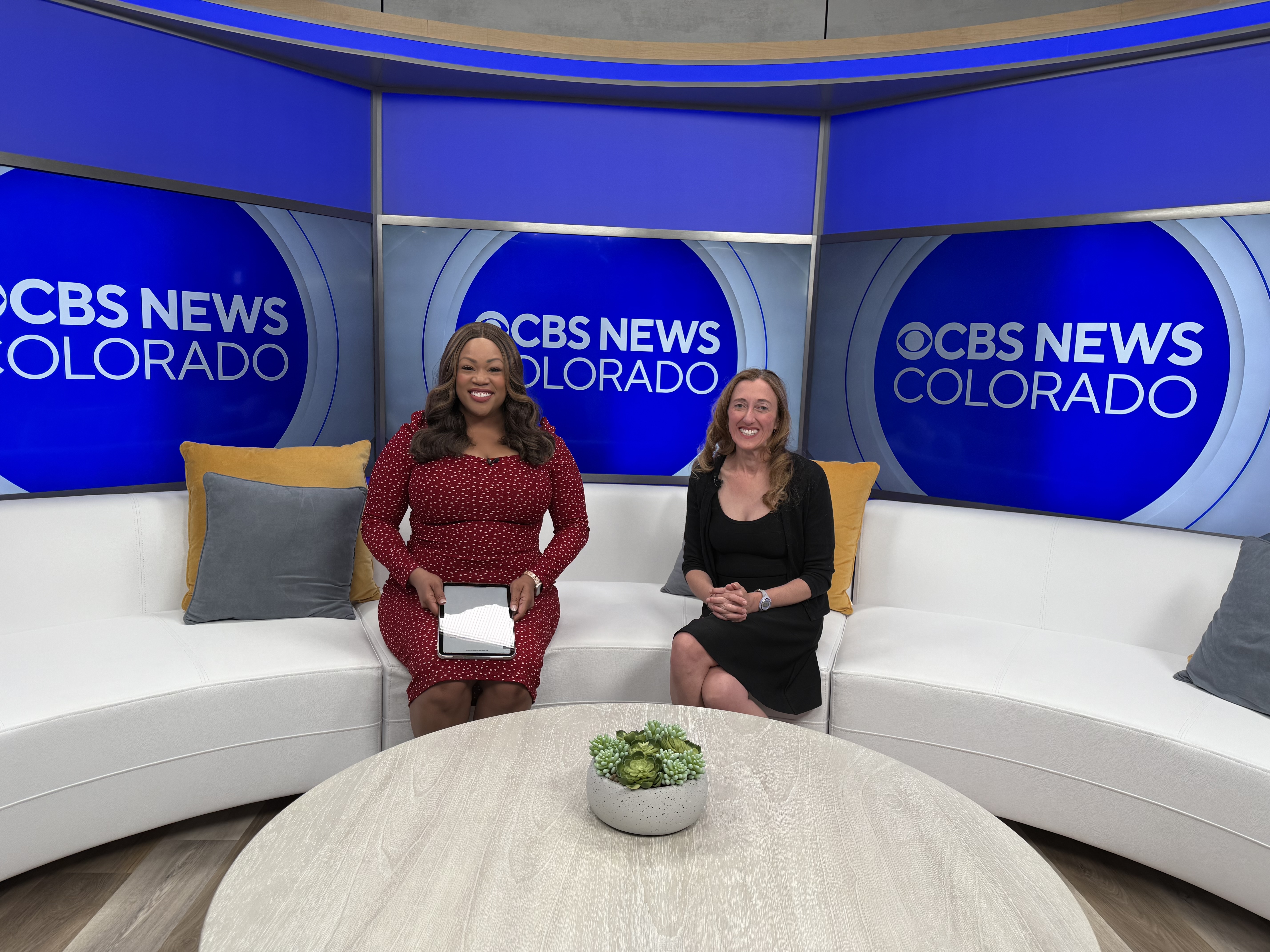 Dr. Schmidt and news anchor on set of CBS News Colorado.