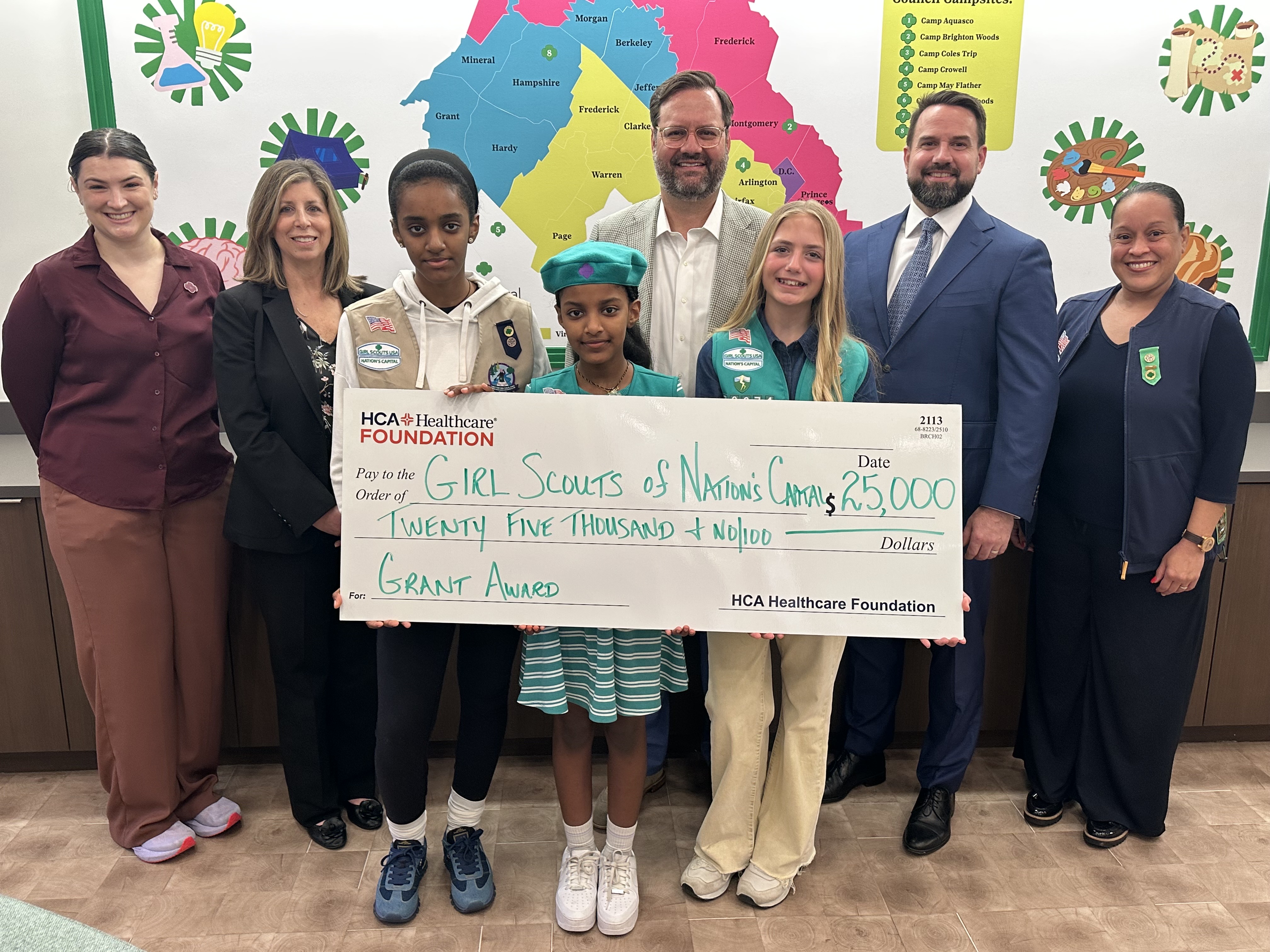 group photo of HCA Healthcare Foundation members and girl scouts with grant check