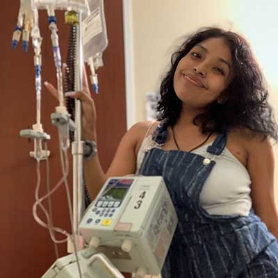 Katelyn Huchin next to hospital machinery.