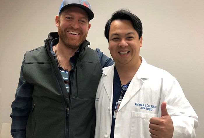 Aaron Kendle and his heart surgeon Dr. Kim de la Cruz, smiling.