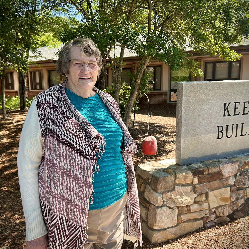 Rose standing in front of the Keever Building.