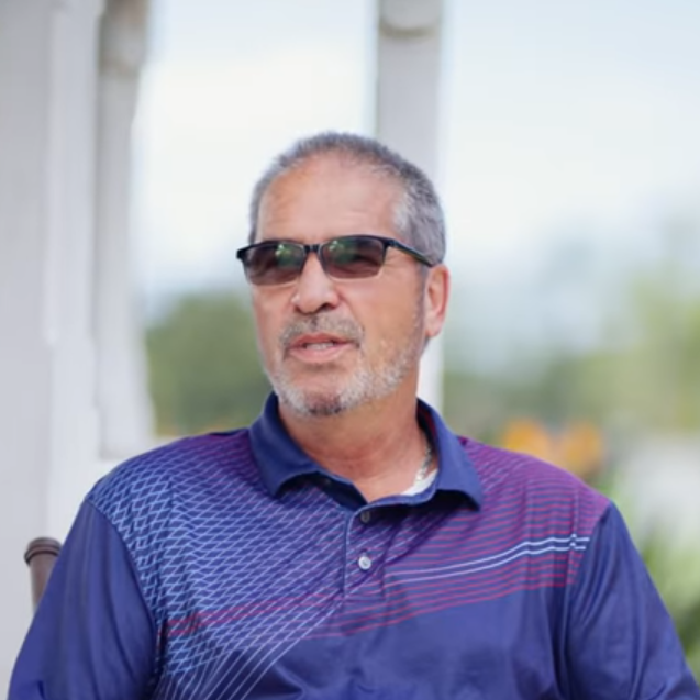 Anthony Salamone in sunglasses being interviewed for the video on the golf course.