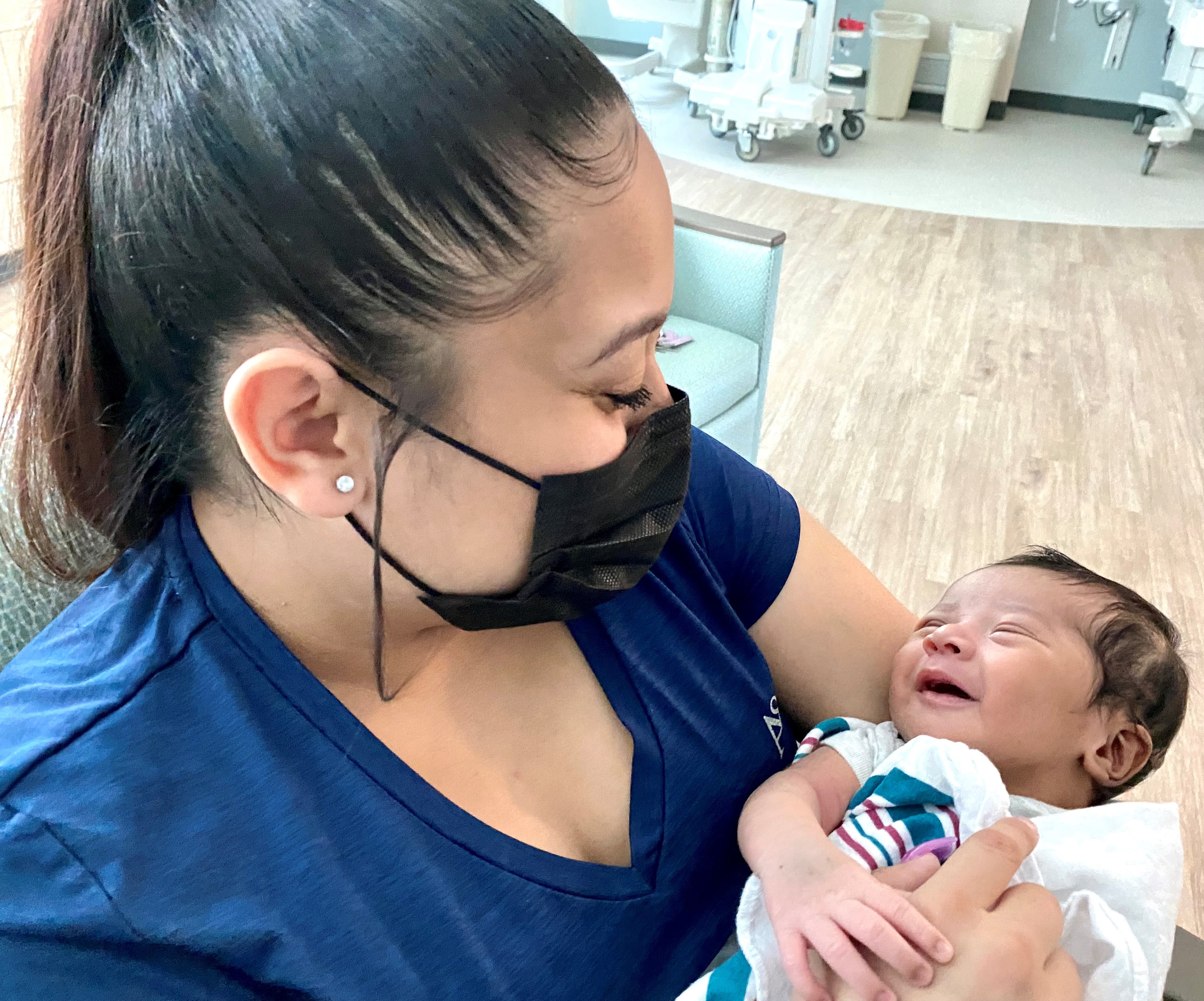 Eva Lopez holding her son