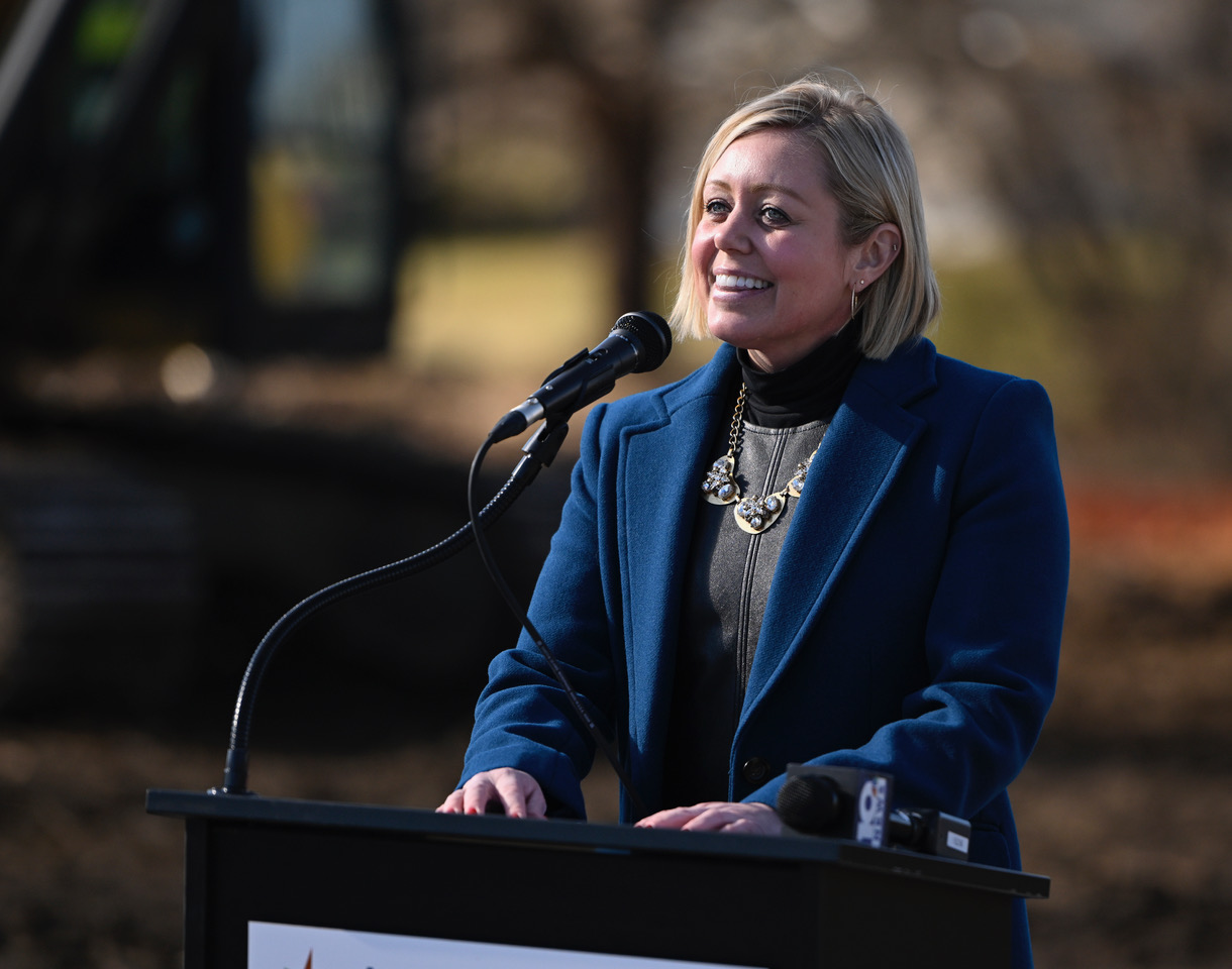 Woman standing at a podium.