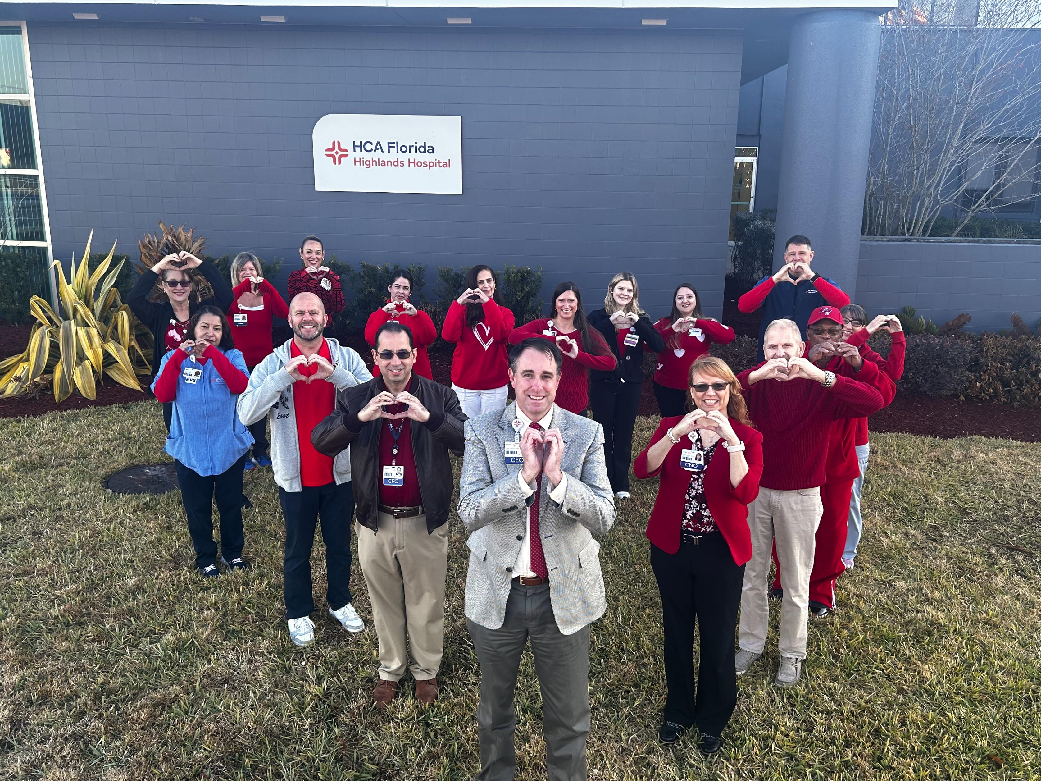 Team members posing for photo outside of Highlands Hospital while wearing red for National Wear Red Day.